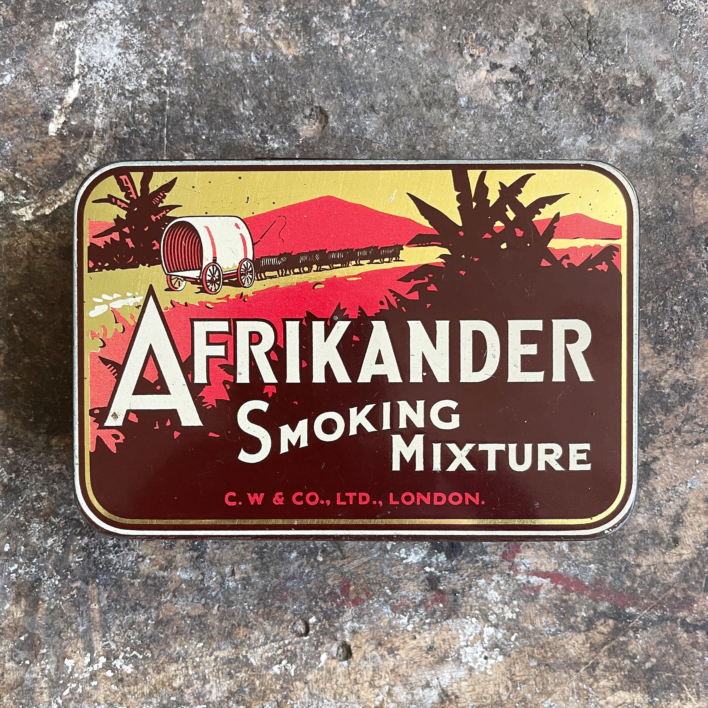 A large vintage Afrikander Smoking Mixture Tin from the 1930s with great colours and graphics to the front and inside hinged lid. Great, fresh condition - SHOP NOW - www.intovintage.co.uk