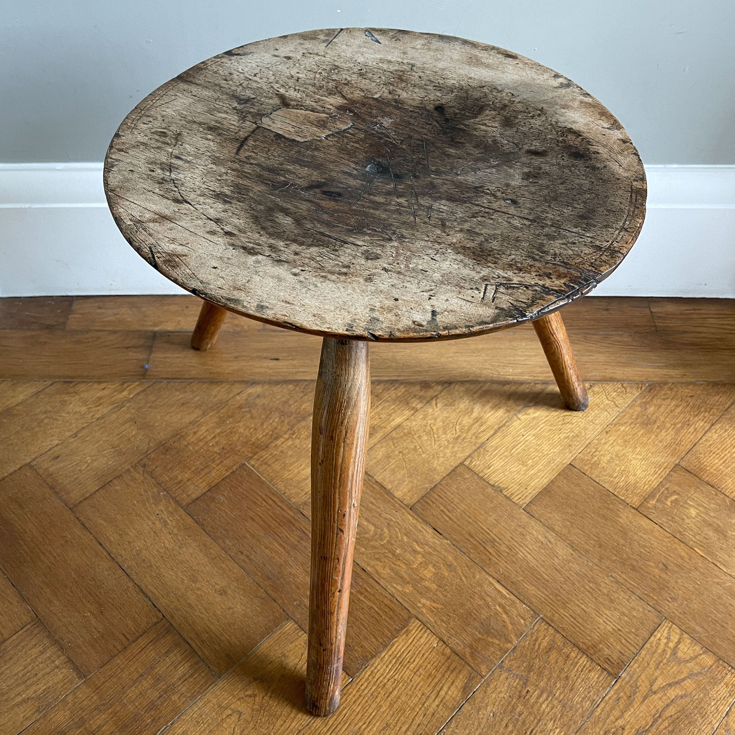 An Antique Ash Milking Stool with a beautifully aged deep and wide turned seat. Sitting on three cylindrically shaped legs. A beautiful piece and super solid - SHOP NOW - www.intovintage.co.uk