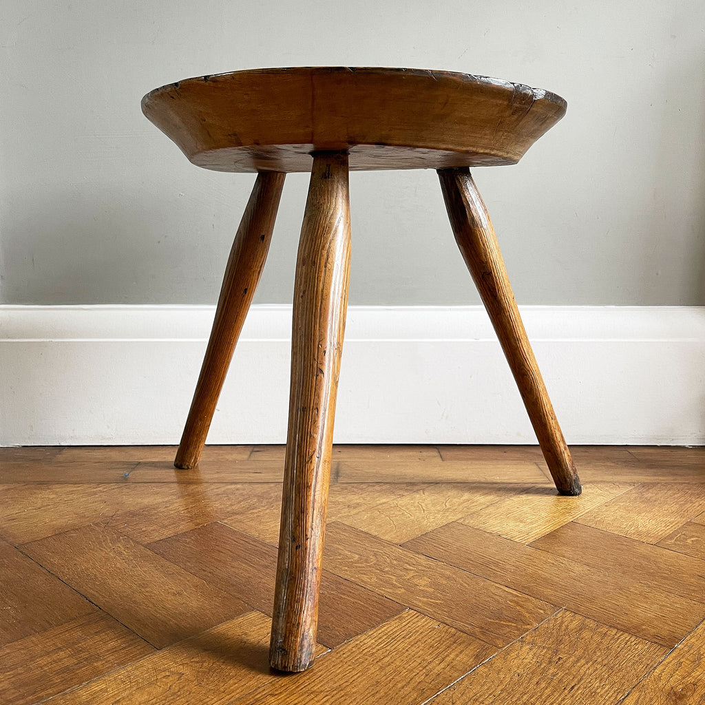 An Antique Ash Milking Stool with a beautifully aged deep and wide turned seat. Sitting on three cylindrically shaped legs. A beautiful piece and super solid - SHOP NOW - www.intovintage.co.uk
