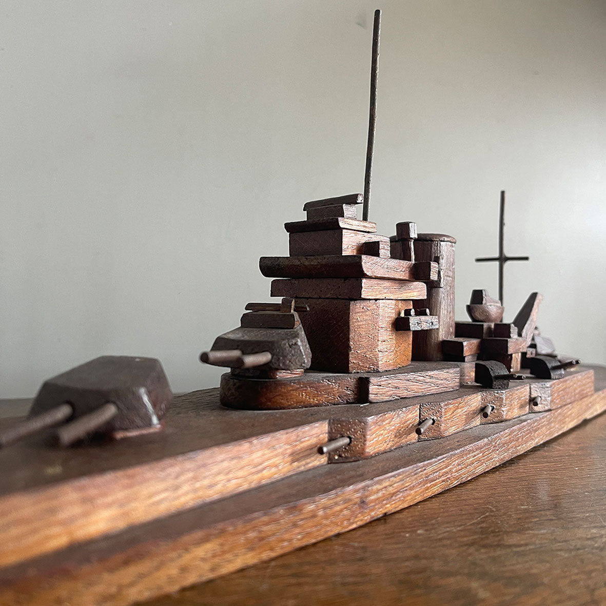 An 1940's vintage oak scratch-built battleship. Superbly built with perfect proportions, masts and fantastic rotating gun turrets. It has a flat bottom, so easy to display - SHOP NOW - Iintovintage.co.uk