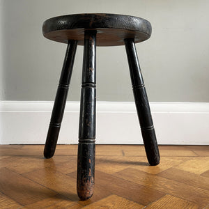 An Antique Pine Milking Stool with a wonderful original black painted finish that has worn away over its years of use to provide the great finish. Very solid and sitting on three turned legs - SHOP NOW - www.intovintage.co.uk