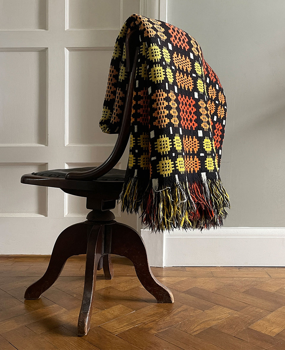 A pure wool Welsh Tapestry blanket in Black, Orange, Red, White and Yellow - SHOP NOW - www.intovintage.co.uk