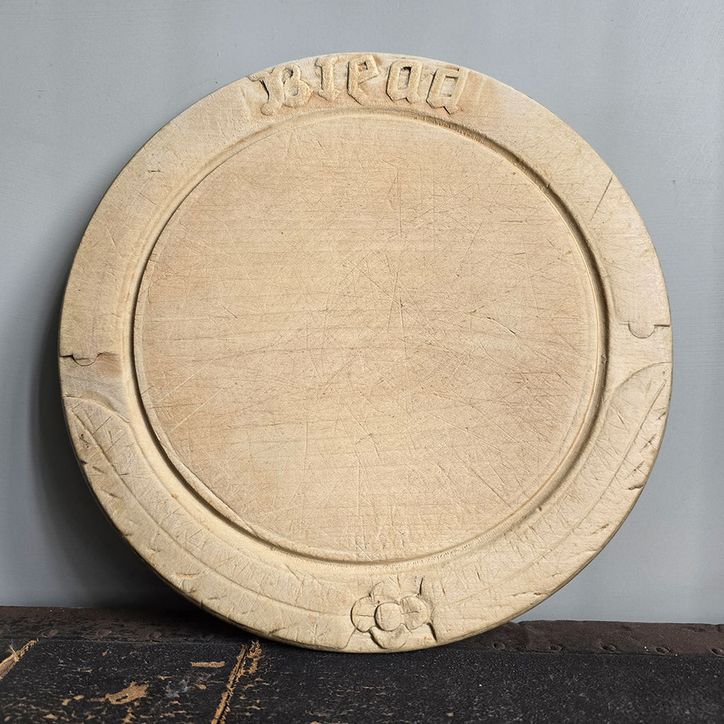 An Edwardian Carved Sycamore Bread Board with the word 'Bread' and a bottom rosette carved on its border - Nicely worn with a pale patina - SHOP NOW - www.intovintage.co.uk