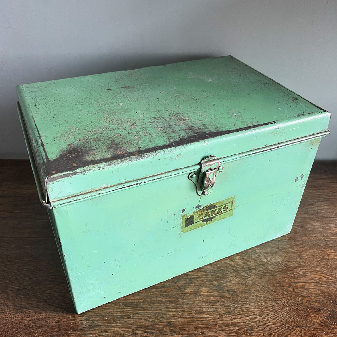 A Vintage Garrison Cake Tin in a fab duck egg green, and still having its 'CAKES' water slide sticker to the front. Open up the latch and find an inner tray that lifts out to reveal a larger space beneath - SHOP NOW - www.intovintage.co.uk