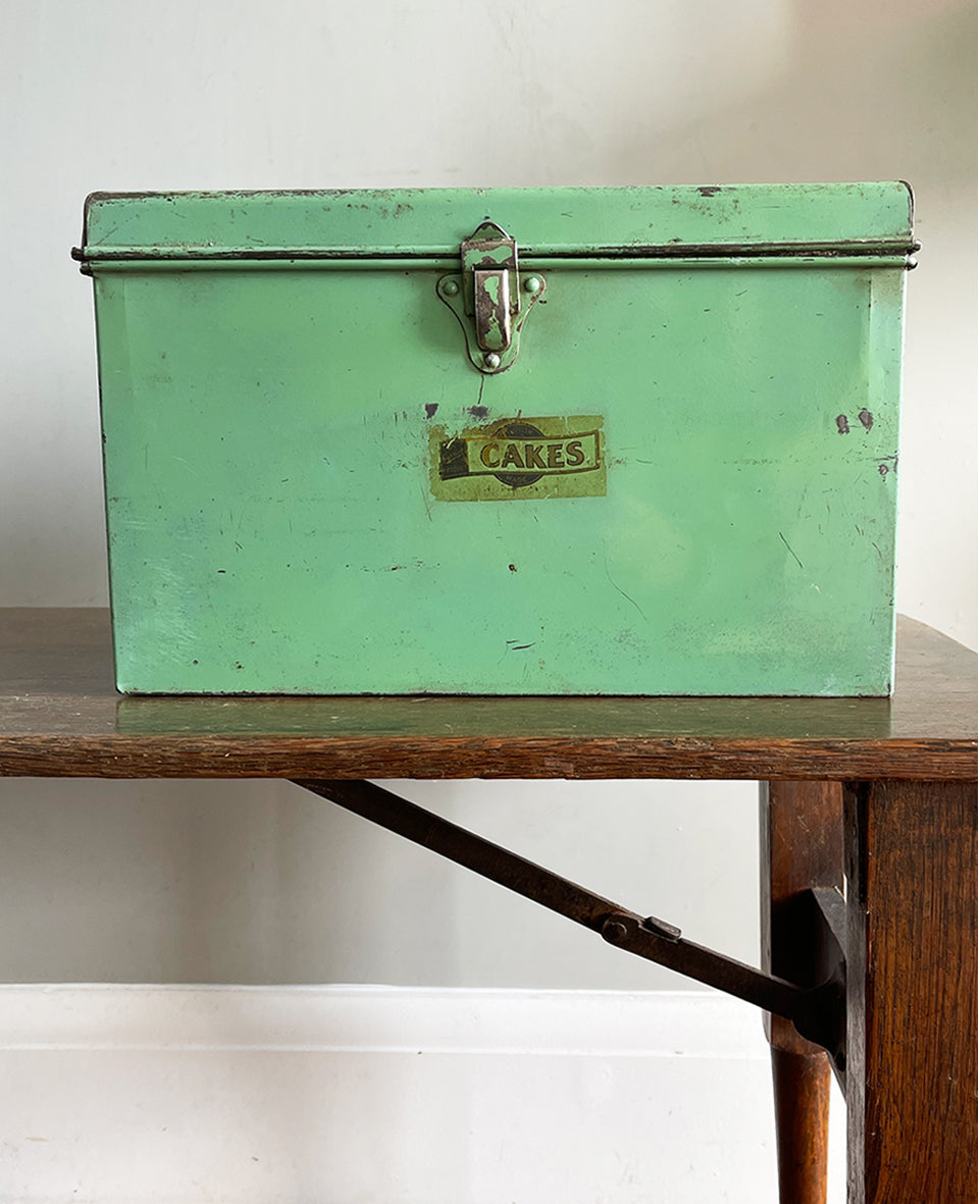 A Vintage Garrison Cake Tin in a fab duck egg green, and still having its 'CAKES' water slide sticker to the front. Open up the latch and find an inner tray that lifts out to reveal a larger space beneath - SHOP NOW - www.intovintage.co.uk