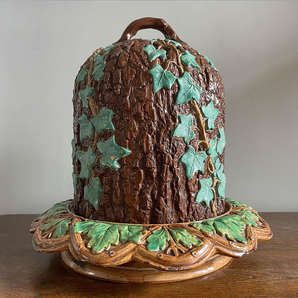 An unusual Victorian Majolica ware Stilton Cheese Keeper. The top dome is decorated in an oak bark design with sprigs of green ivy growing up the sides and a styled branch handle. The base sees an oak leaf pattern with an entwined branch design - SHOP NOW - www.intovintage.co.uk