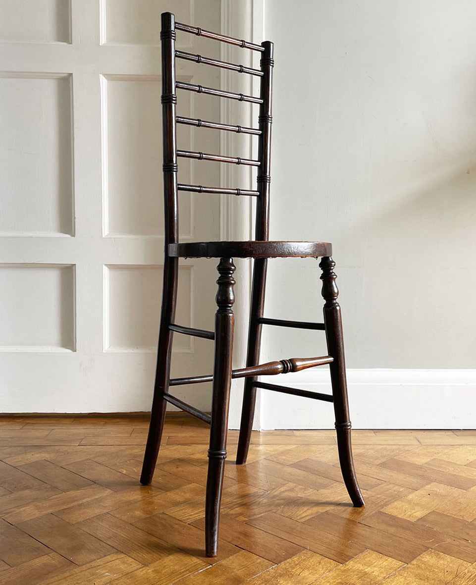 An exceptional example of an 19th Century deportment or correction chair. A beautifully turned ladder back, caned seat with turned and splayed legs. - SHOP NOW - www.intovintage.co.uk