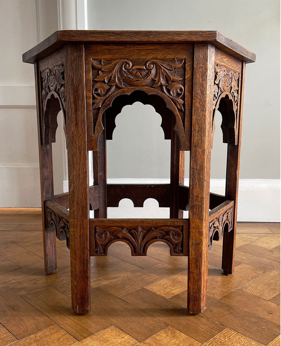 A good looking Carved Oak Side Table. The hexagonal top sees a beautiful hand-carved decorative leaf border with further carving to each of the six side panels. 