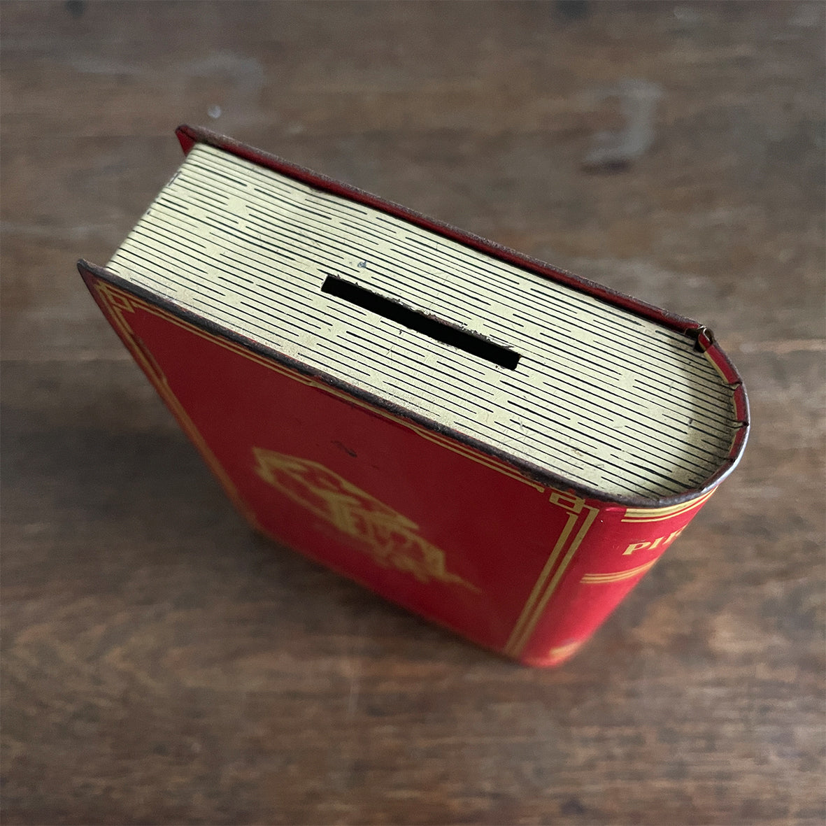 A Vintage 1950s Chad Valley Pirate Tin-Plate Money Box that looks like a book. With a cracking pirate image to the front and the word 'PIRATES' on the spine - SHOP NOW - www.intoVintage.co.uk