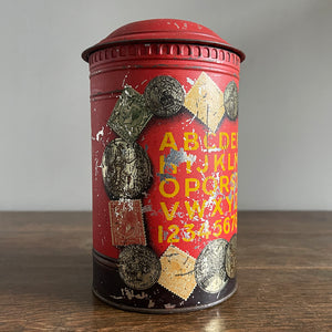 An charming early 20th Century Post Box Tin with lid. It has a slot for your pennies and a handy alphabet on the reverse edged with coins and stamps - SHOP NOW - www.intovintage.co.uk