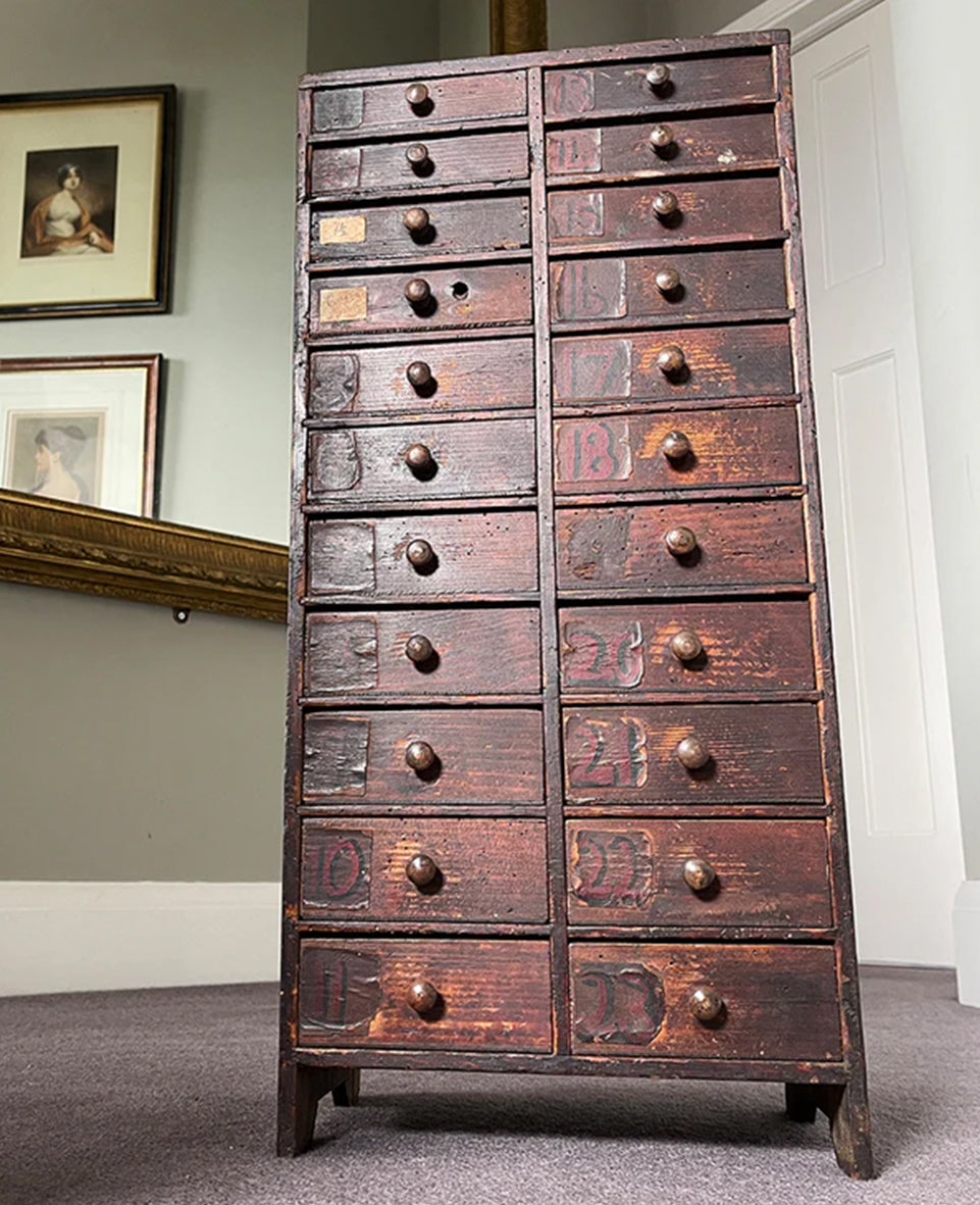 A fantastic set of Watchmakers Draws. Finished in a time worn dark pine, it has 22 draws (descending in size) each one with a wooden turned handle. The draws themselves are individually numbered with a hand painted numeral, with some of them still having their little compartmented areas - SHOP NOW - www.intovintage.co.uk