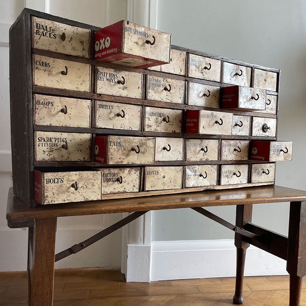 A wonderful set of mechanics scratch-built work drawers with a secret... every single drawer is made from an old OXO tin and the maker who created the piece has carefully hand painted serif titles on each of the drawers fronts - SHOP NOW - www.intovintage.co.uk