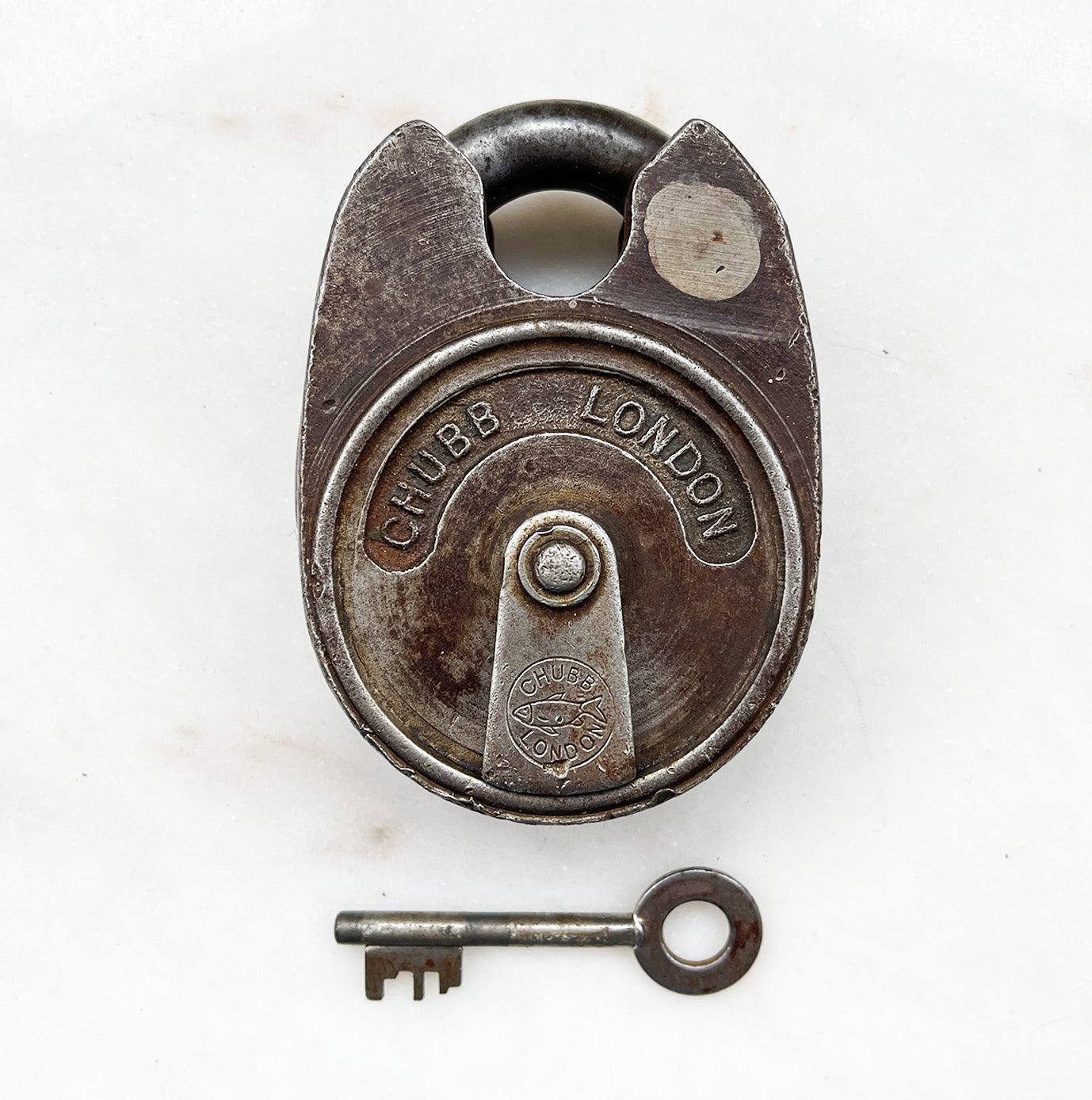 A large chunky vintage Chubb Padlock with a wonderful patina to its surface. Marked 'CHUBB LONDON' with the Chubb fish emblem on the key hole cover. Stamped '669' to the rear. Very solid with a satisfying clunk when locked. Fully working with key.  - SHOP NOW - www.intovintage.co.uk