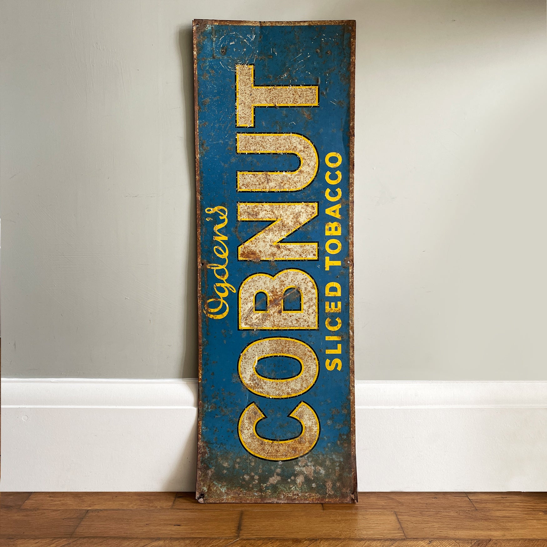 A 1930s Ogden's Cob Nut Sliced Tobacco Tin Sign. In a fantastic bright blue with yellow and black highlights around white type.warm yellow with dark blue type. - SHOP NOW - www.intovintage.co.uk