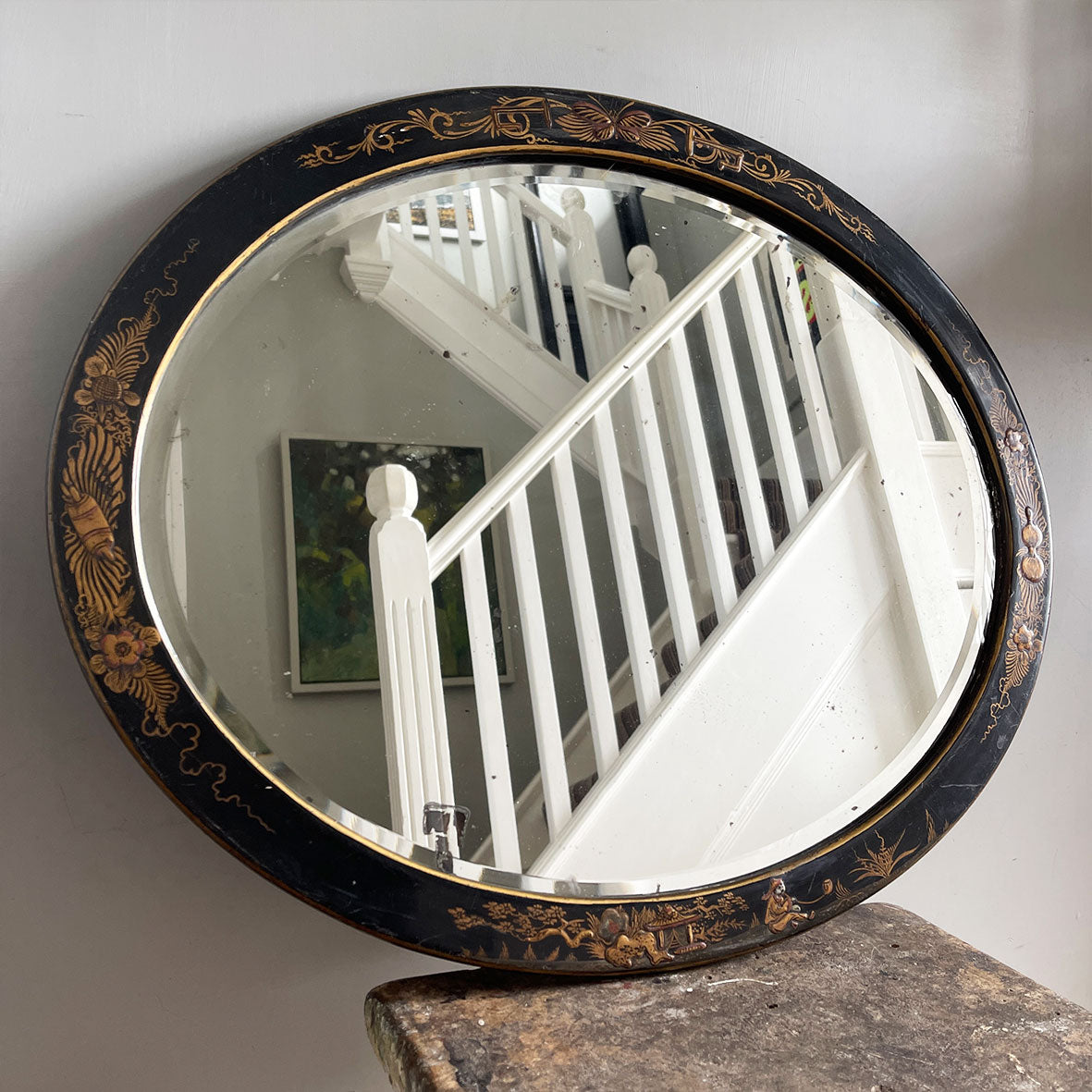 An Antique quality decorated black lacquer oval wall mirror. The original mirrored glass is beveled, has good foxing and is in good condition - SHOP NOW - www.intovintage.co.uk