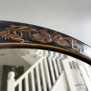 An Antique quality decorated black lacquer oval wall mirror. The original mirrored glass is beveled, has good foxing and is in good condition - SHOP NOW - www.intovintage.co.uk