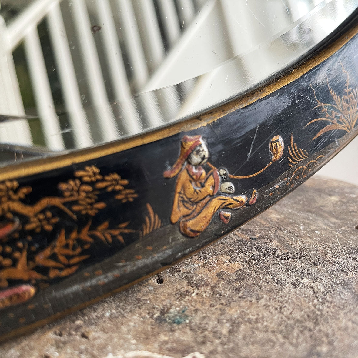 An Antique quality decorated black lacquer oval wall mirror. The original mirrored glass is beveled, has good foxing and is in good condition - SHOP NOW - www.intovintage.co.uk