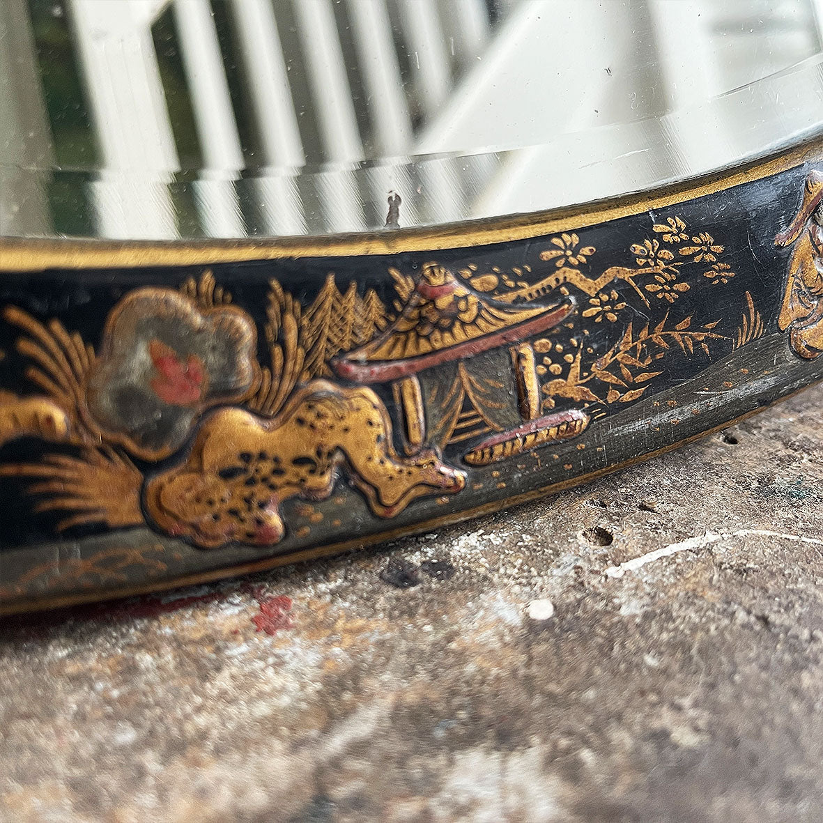 An Antique quality decorated black lacquer oval wall mirror. The original mirrored glass is beveled, has good foxing and is in good condition - SHOP NOW - www.intovintage.co.uk