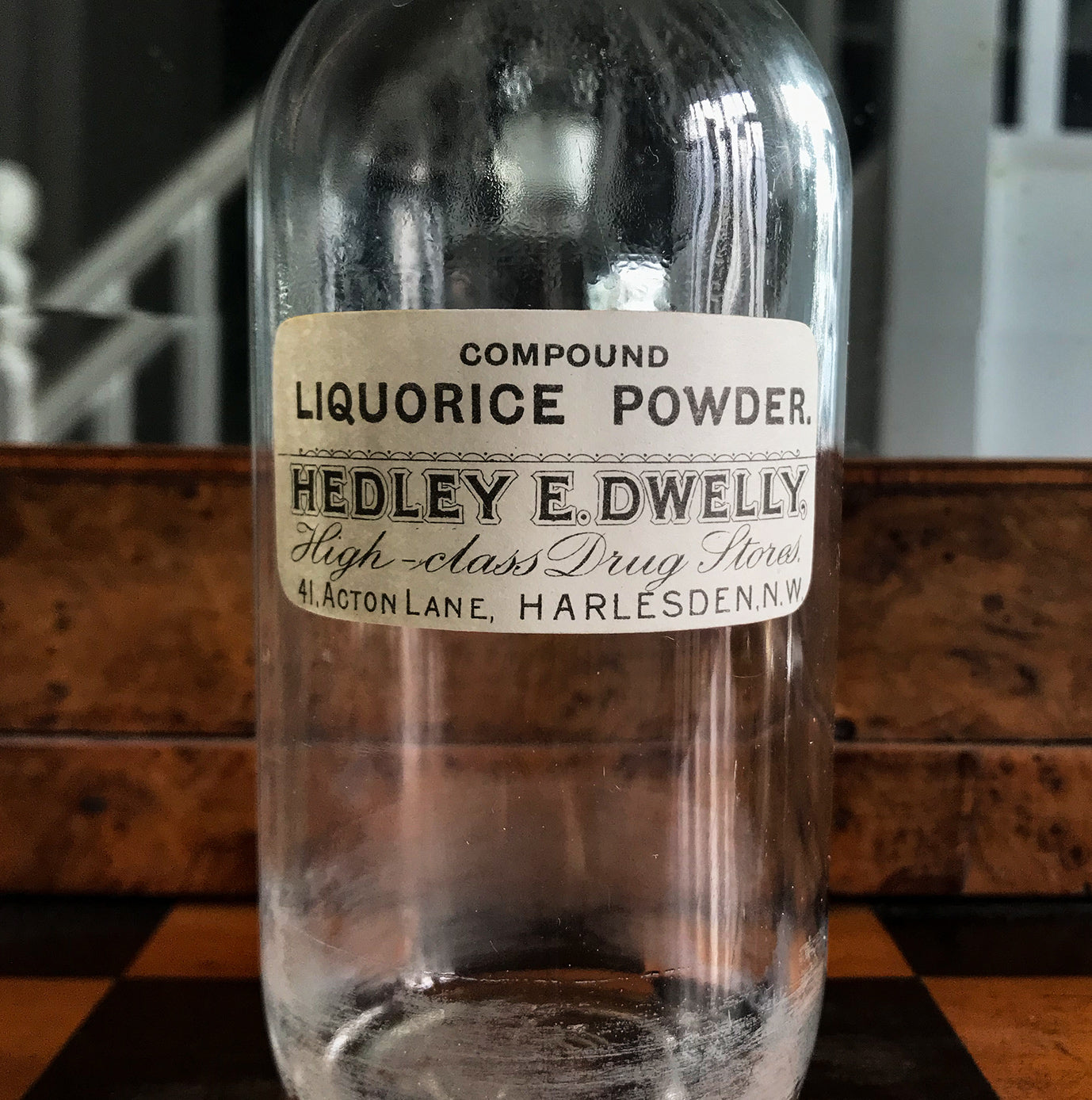 Vintage Clear Apothecary Bottle with an original paper label from Hedley E. Dwelly, High-Class Drug Stores, 41, Acton Lane, Harlesden. N.W. - SHOP NOW - www.intovintage.co.uk