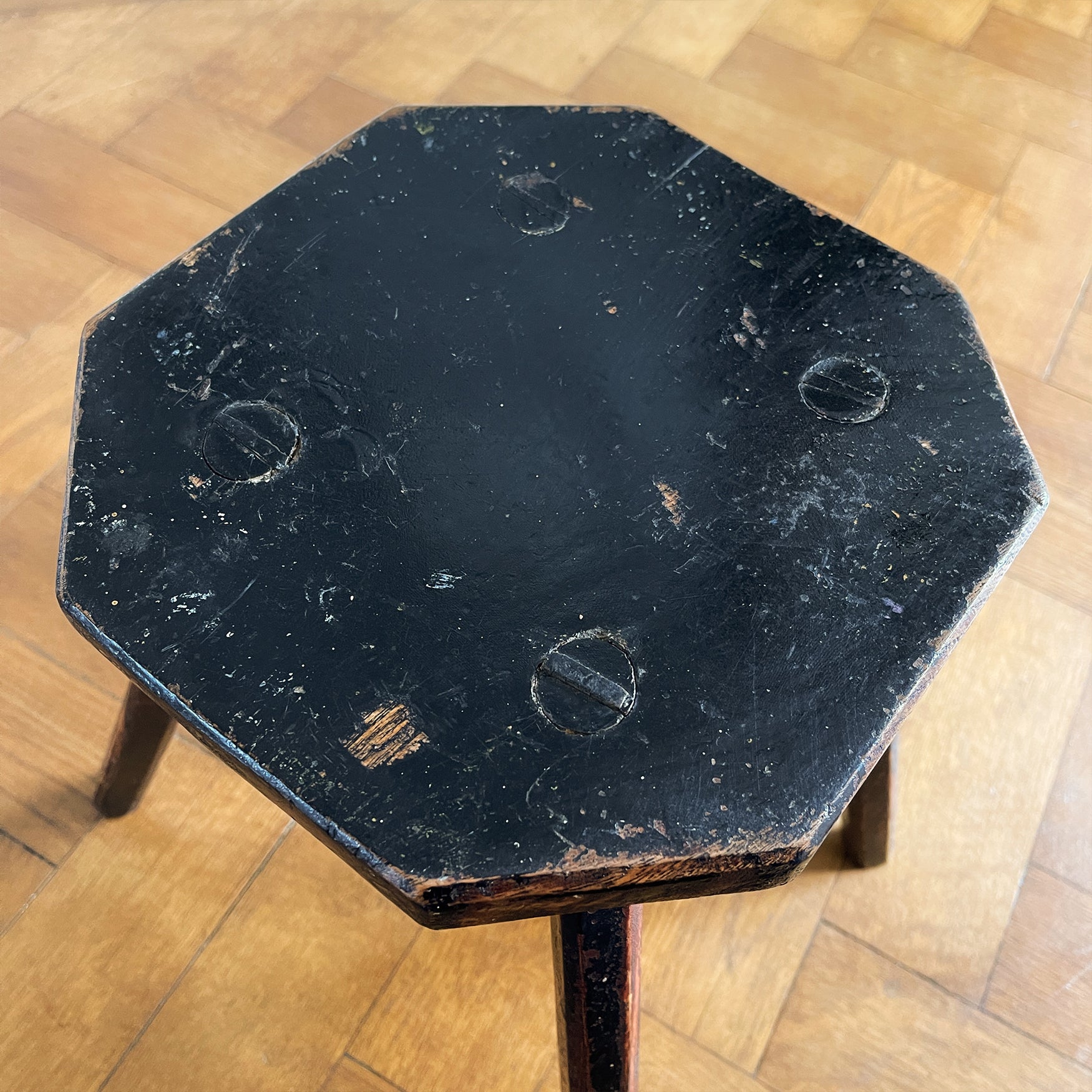 An Antique Elm Milking Stool with a wonder original black painted finish that has worn away over its years of use to provide the perfect finish. Very solid and sitting on four tapered straight edged legs -SHOP NOW - www.intovintage.co.uk