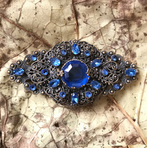 Excellent quality Edwardian Brooch with intricate design detail. Numerous faceted glass sapphires surrounding one larger blue glass gem. - SHOP NOW -  www.intovintage.co.uk